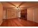 Living room with hardwood floors, brick fireplace, ceiling fan, and built-in shelves at 750 Mount Vernon Hwy, Atlanta, GA 30327