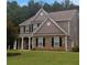 Two-story house with stone accents and a covered porch at 324 Mary Dr, Mcdonough, GA 30252