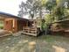 Backyard with wooden deck, attached sunroom, and carport covering at 439 Oakside Dr, Atlanta, GA 30331