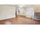 Living room with hardwood floors, neutral walls, and a staircase at 3188 Warrenton Ct, Douglasville, GA 30135