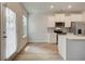 Modern kitchen with white cabinetry, stainless steel appliances, and a view to the backyard at 520 Payne Dr, Mcdonough, GA 30253