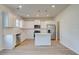 Bright, open kitchen featuring white cabinets, stainless steel appliances, and an island at 30 Begonia Ct, Covington, GA 30016