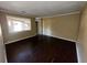 Empty room with dark wood-look floors, large window, and neutral walls at 2228 Emerald Castle Dr, Decatur, GA 30035