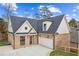Brick home with a two-car garage and dormer windows at 110 Cottage Gate Ln, Roswell, GA 30076