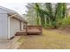 Backyard with a wooden deck, surrounded by trees and grass at 453 Utoy Sw Cir, Atlanta, GA 30331