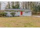 Charming single-story home with a red door and gray brick exterior at 453 Utoy Sw Cir, Atlanta, GA 30331