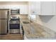 Updated kitchen with stainless steel appliances, white cabinets, and granite countertops at 453 Utoy Sw Cir, Atlanta, GA 30331