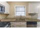 Sleek kitchen with white shaker cabinets, granite counters, and a stainless steel sink and appliances at 453 Utoy Sw Cir, Atlanta, GA 30331