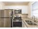 Bright kitchen with white cabinets, stainless steel appliances, and granite countertops at 453 Utoy Sw Cir, Atlanta, GA 30331