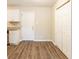 Kitchen and dining area with white cabinets, granite countertops, and wood-look flooring at 453 Utoy Sw Cir, Atlanta, GA 30331