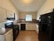 Bright kitchen featuring white cabinets, black appliances, and tile backsplash at 2326 Union Grove Ct, Lithonia, GA 30058