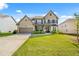 Brick two-story house with a 2 car garage and landscaped yard at 5290 Austrian Pine Ct, Cumming, GA 30040