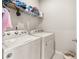 Bright laundry room, complete with washer, dryer, and shelving for storage at 5290 Austrian Pine Ct, Cumming, GA 30040