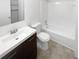 Clean bathroom with white fixtures, a shower/tub combo, and dark wood vanity at 4727 Garden Hills Dr, Stone Mountain, GA 30083