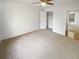 Spacious bedroom with carpet, closet, and door to another room at 4727 Garden Hills Dr, Stone Mountain, GA 30083