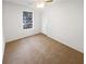 Unfurnished bedroom with neutral carpeting and a large window at 4727 Garden Hills Dr, Stone Mountain, GA 30083
