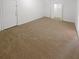 Carpeted bedroom with open closet and entry door at 4727 Garden Hills Dr, Stone Mountain, GA 30083