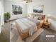 Cozy bedroom featuring carpet, a large window, and a comfortable bed at 4727 Garden Hills Dr, Stone Mountain, GA 30083