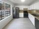 Modern kitchen with white cabinets, stainless steel appliances, and tile flooring at 4727 Garden Hills Dr, Stone Mountain, GA 30083