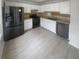 Updated kitchen with stainless steel appliances, white cabinets, and tile floor at 4727 Garden Hills Dr, Stone Mountain, GA 30083