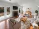 Bright living room with a brick fireplace, French doors, and stylish furniture at 4727 Garden Hills Dr, Stone Mountain, GA 30083