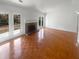 Spacious living area with a brick fireplace, parquet flooring, and French doors at 4727 Garden Hills Dr, Stone Mountain, GA 30083