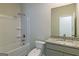 Bathroom with tub/shower combo, granite vanity, and modern fixtures at 1628 Fuma Leaf Way, Mcdonough, GA 30253