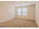 Empty bedroom with neutral carpet and two windows with blinds at 1628 Fuma Leaf Way, Mcdonough, GA 30253