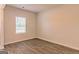 Empty bedroom with wood-look flooring and large window at 1628 Fuma Leaf Way, Mcdonough, GA 30253