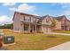 Two-story home with brick exterior, front yard landscaping, and attached two-car garage at 1628 Fuma Leaf Way, Mcdonough, GA 30253