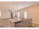 Kitchen island with granite countertops, stainless steel dishwasher, and pendant lights at 1628 Fuma Leaf Way, Mcdonough, GA 30253