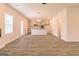 Open-concept kitchen and dining area with wood-look flooring and modern light fixtures at 1628 Fuma Leaf Way, Mcdonough, GA 30253