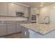 Kitchen featuring granite countertops, stainless steel appliances, and gray cabinetry at 1628 Fuma Leaf Way, Mcdonough, GA 30253