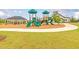 Community playground with slides, climbing structures, and a covered picnic area at 1628 Fuma Leaf Way, Mcdonough, GA 30253
