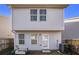 Back exterior of a two-story home with windows, a back door, and an AC unit at 2137 Belmont Cir, Conyers, GA 30012