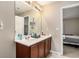 Main bathroom with double vanity, large mirror, and wooden cabinets at 2137 Belmont Cir, Conyers, GA 30012