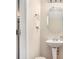 Half bathroom with a pedestal sink, oval mirror, and soft neutral walls at 2137 Belmont Cir, Conyers, GA 30012