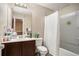 Bathroom with shower/tub combo, single vanity, and dark wood cabinets at 2137 Belmont Cir, Conyers, GA 30012