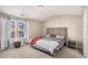 Spacious main bedroom with plush carpet, tufted headboard, and windows at 2137 Belmont Cir, Conyers, GA 30012