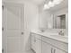 Bathroom with double vanity, white cabinets, and marble-look tile flooring at 3834 Kastler Dr, South Fulton, GA 30349