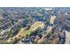 An aerial view of homes and a golf course, surrounded by trees at 3229 Carmichael Pl, Duluth, GA 30097