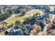 Aerial view showcasing a beautiful golf course community with trees and homes at 3229 Carmichael Pl, Duluth, GA 30097