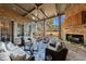 Spacious covered porch with a fireplace, comfy seating, and views at 3229 Carmichael Pl, Duluth, GA 30097