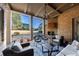 Covered back porch with fireplace, seating area, and golf course view at 3229 Carmichael Pl, Duluth, GA 30097