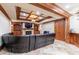 Cozy basement living area with fireplace, built-in shelves, and leather sectional at 3229 Carmichael Pl, Duluth, GA 30097