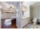 View of a bathroom with white vanity, toilet, and tiled floor from main bedroom at 3229 Carmichael Pl, Duluth, GA 30097