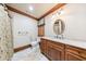 Bathroom with tiled floor, vanity with granite countertop, and decorative mirror at 3229 Carmichael Pl, Duluth, GA 30097