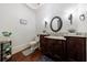 Bathroom with granite countertop, dark wood vanity, and elegant light fixtures at 3229 Carmichael Pl, Duluth, GA 30097