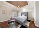 Bedroom with tray ceiling, window seat, and plush bed at 3229 Carmichael Pl, Duluth, GA 30097