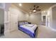 Bedroom with carpeted floors, ceiling fan, and ensuite bathroom at 3229 Carmichael Pl, Duluth, GA 30097